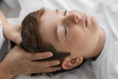 Boy receiving craniosacral therapy