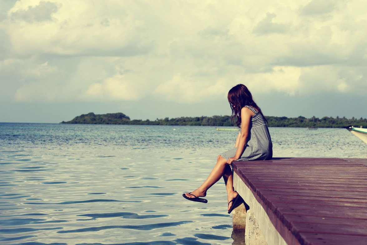 Girl relaxing on a boat peer